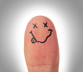 Image showing Female thumbs with smile face on the finger