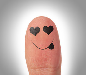 Image showing Female thumbs with smile face on the finger