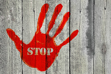 Image showing Handprint with the word ''Stop'' on old wooden fence background