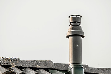 Image showing Metal chimney on the top a roof