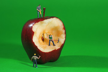 Image showing Construction Workers in Conceptual Imagery With an Apple