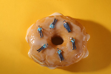 Image showing Police Officers in Conceptual Food Imagery With Donuts