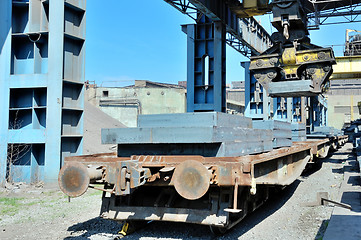 Image showing crane loading steel stack 