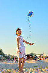 Image showing young girl flying a kite on the beach