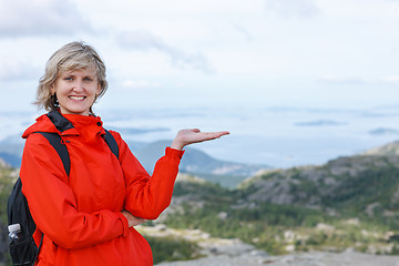 Image showing Happy woman tourist showing blank copy space on the palm