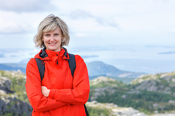 Image showing Portrait of happy woman tourist standing smiling outdoors