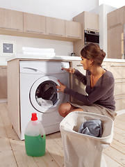 Image showing woman loading the washing machine