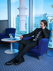 Image showing Business man with laptop in office L