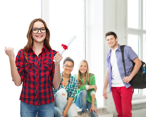 Image showing smiling female student in eyeglasses with diploma