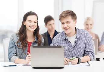 Image showing students with laptop and notebooks at school