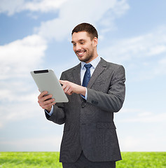 Image showing smiling buisnessman with tablet pc computer