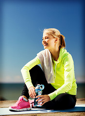 Image showing woman resting after doing sports outdoors