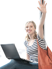 Image showing happy teenage girl waving a greeting