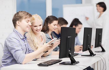 Image showing students with computer monitor and smartphones