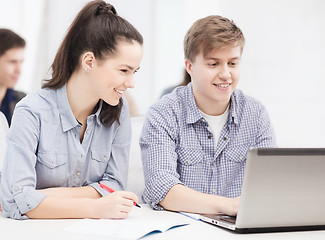 Image showing students with laptop and notebooks at school