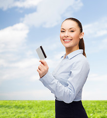 Image showing smiling businesswoman showing credit card