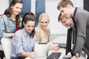 Image showing students with computer monitor and tablet pc