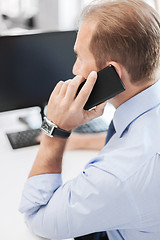 Image showing businessman with smartphone in office