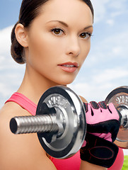 Image showing asian sporty woman with heavy dumbbell