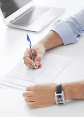 Image showing man signing a contract