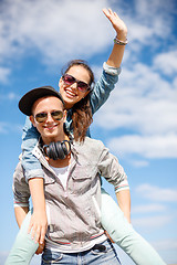 Image showing smiling teenagers in sunglasses having fun outside