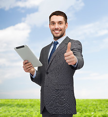 Image showing smiling buisnessman with tablet pc computer