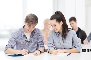 Image showing two teenagers with notebooks at school