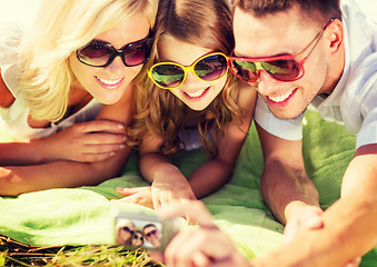 Image showing happy family with camera taking picture