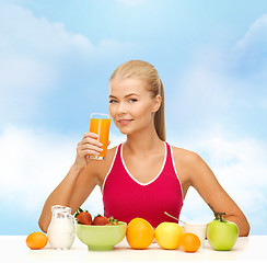 Image showing smiling young woman eating healthy breakfast