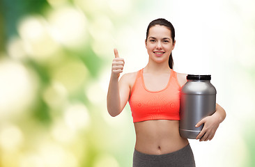 Image showing teenage girl with jar of protein showing thumbs up