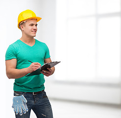 Image showing smiling man in helmet with clipboard