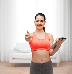 Image showing sporty woman with tablet pc computer