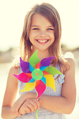 Image showing happy girl with colorful pinwheel toy