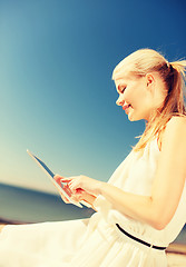 Image showing beautiful woman in a dress with tablet pc