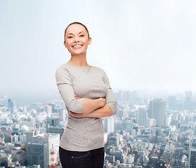 Image showing smiling asian woman over with crossed arms