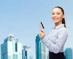 Image showing smiling businesswoman showing credit card