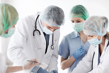 Image showing young group of doctors doing operation