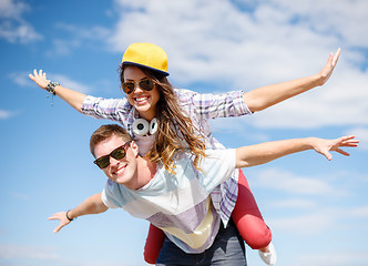 Image showing smiling teenagers in sunglasses having fun outside