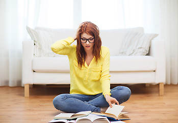 Image showing stressed student girl reading books at home