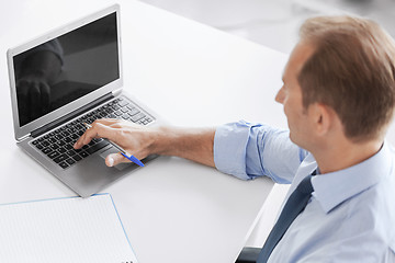 Image showing smiling businessman working in office