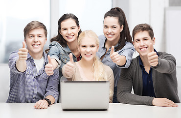 Image showing smiling students with laptop showing thumbs up