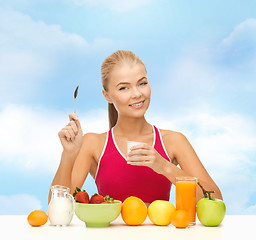 Image showing young woman eating healthy breakfast