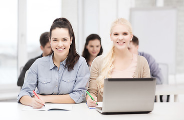 Image showing students with laptop and notebooks at school