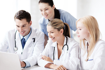 Image showing group of doctors looking at tablet pc