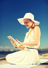 Image showing beautiful woman in a dress with tablet pc