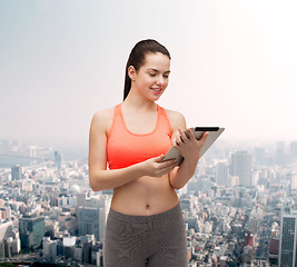 Image showing sporty woman with tablet pc computer