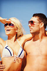 Image showing happy couple in sunglasses on the beach