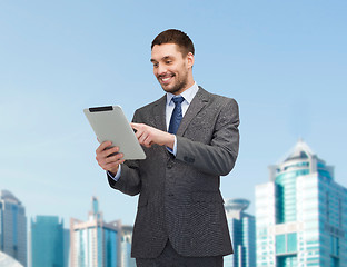 Image showing smiling businessman with tablet pc computer