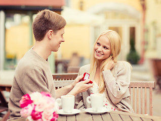 Image showing romantic man proposing to beautiful woman