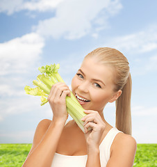 Image showing woman biting piece of celery or green salad